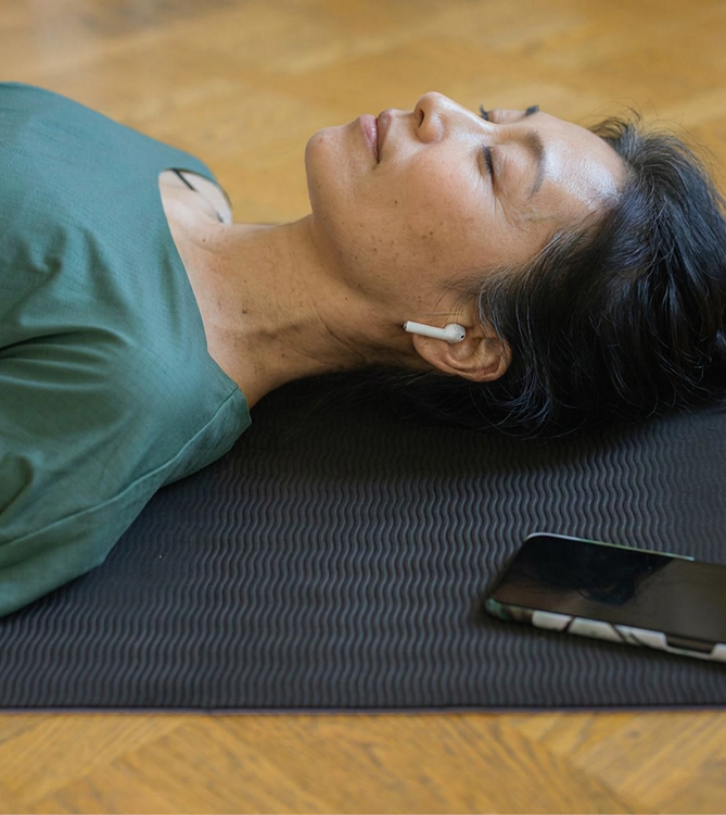 Woman relaxing with earbuds during a session